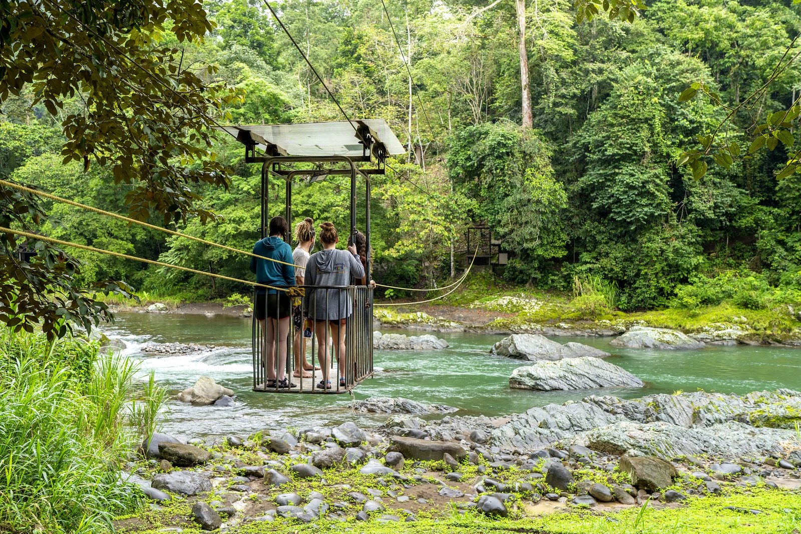 Hikers at a cable crossing over the Pacuare River