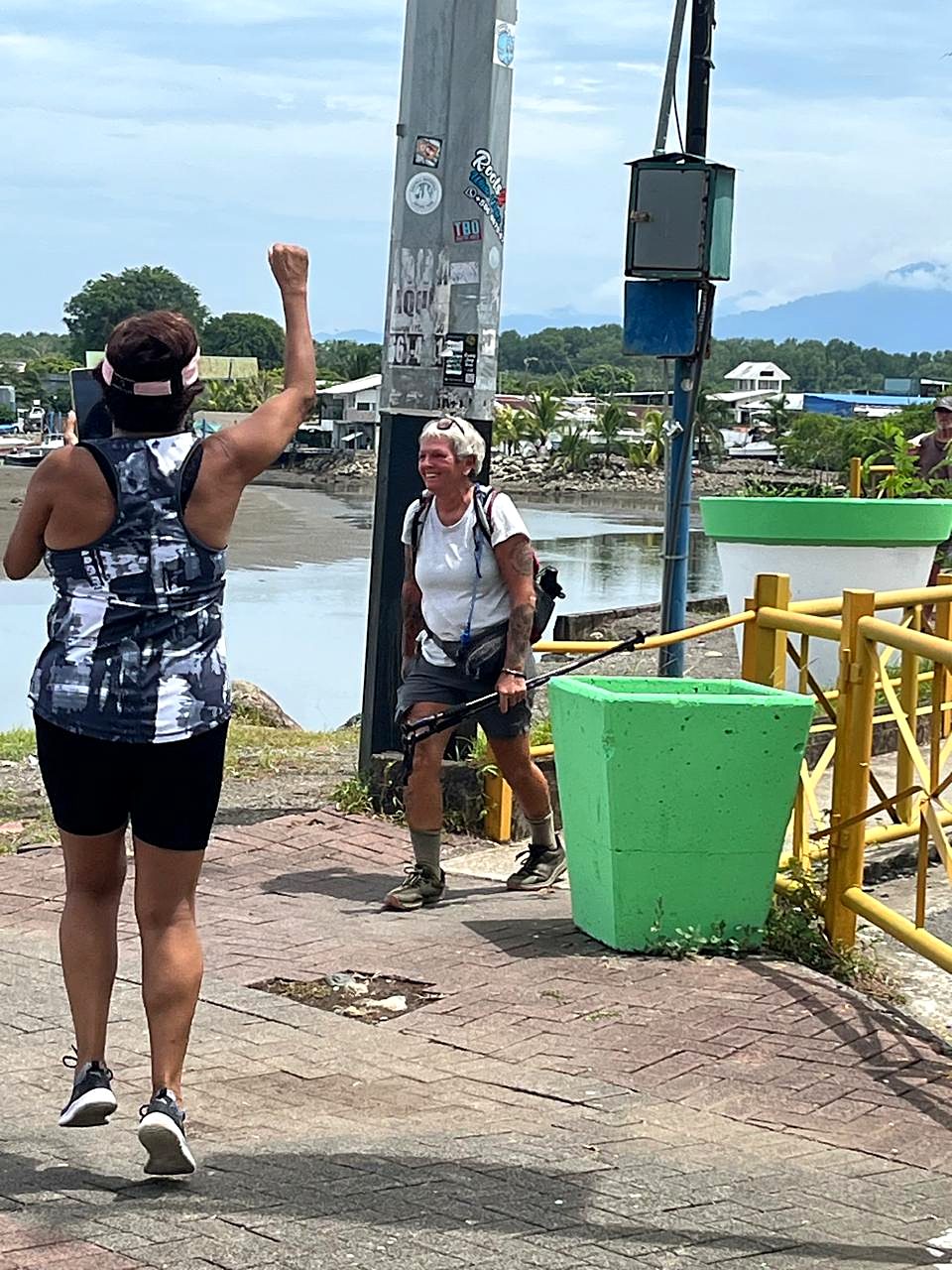 A hiker celebrating at the finish in Quepos, Day 15