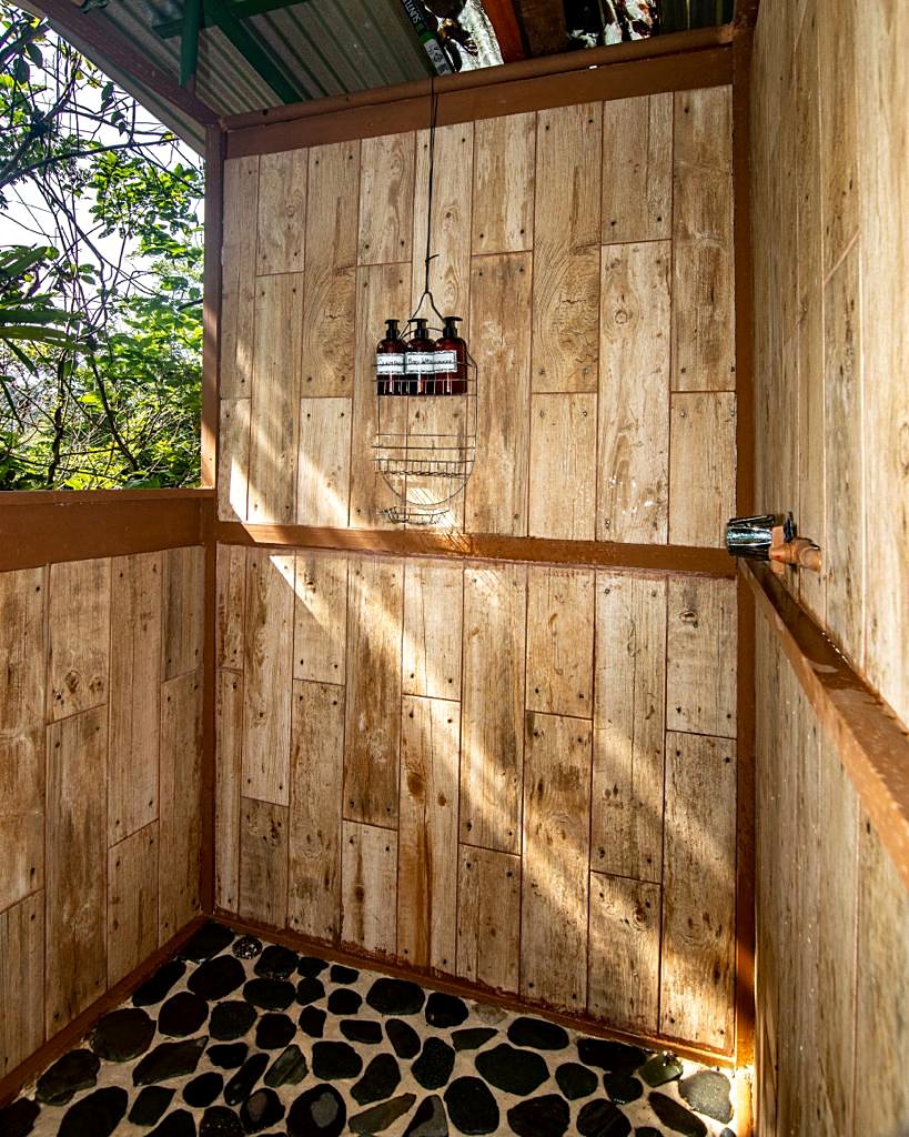Wooden shower with a pebble floor