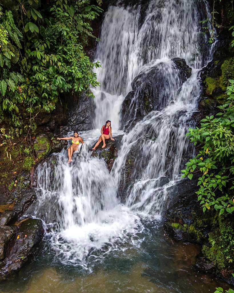 Guests on the rocks in the middle of the waterfall