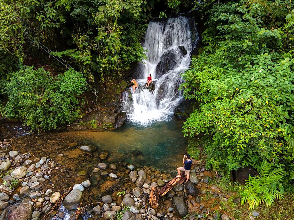 The waterfall and its pool, with guests on the rocks