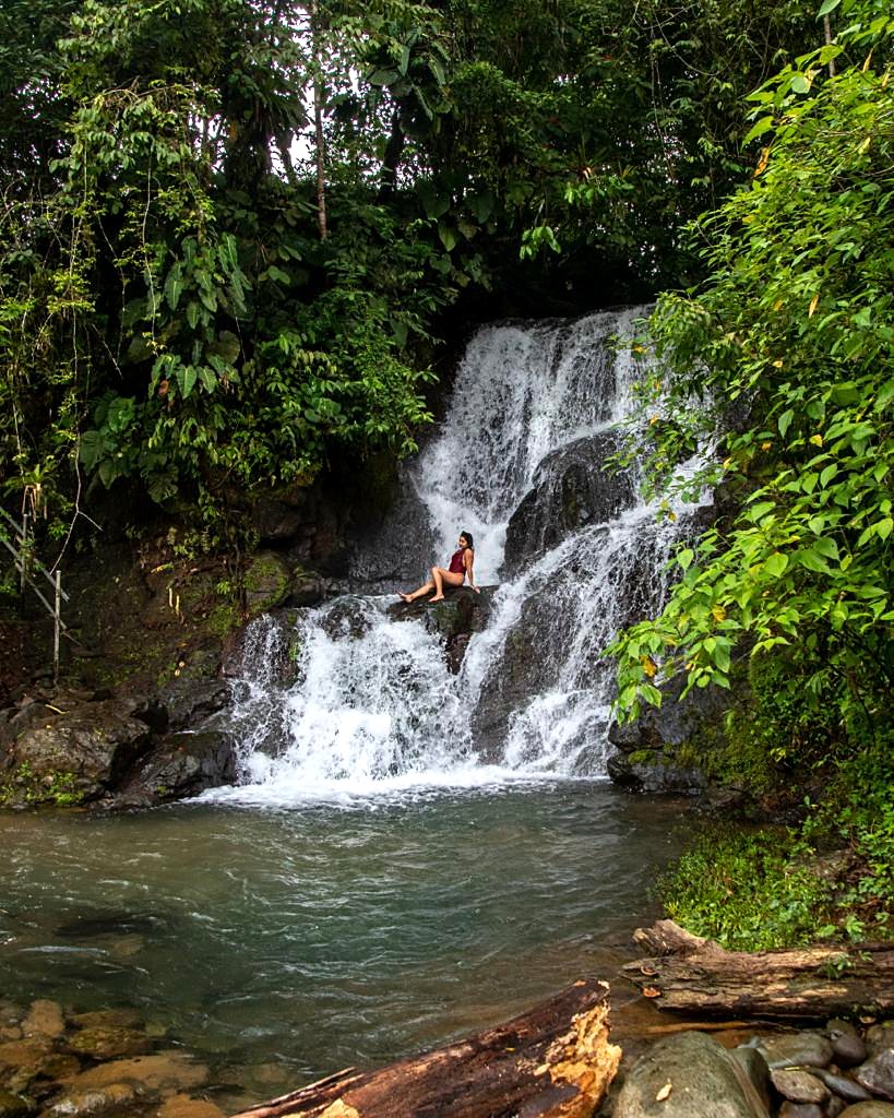 A guest at the base of the waterfall