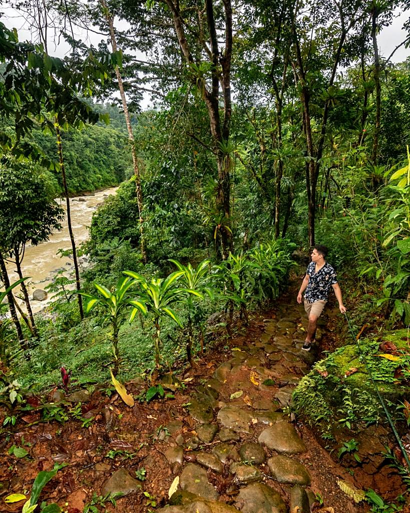 Guest walking the stone path down toward the river
