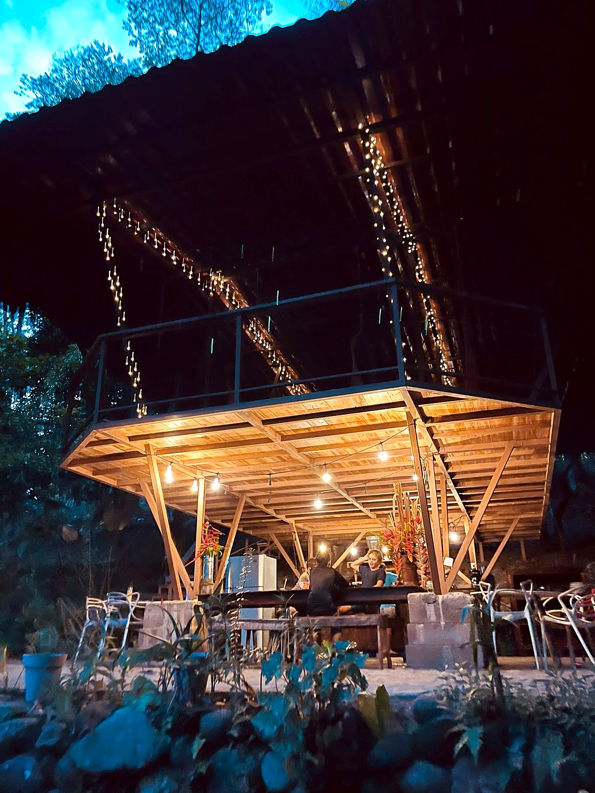 The rancho lit with string lights at night
