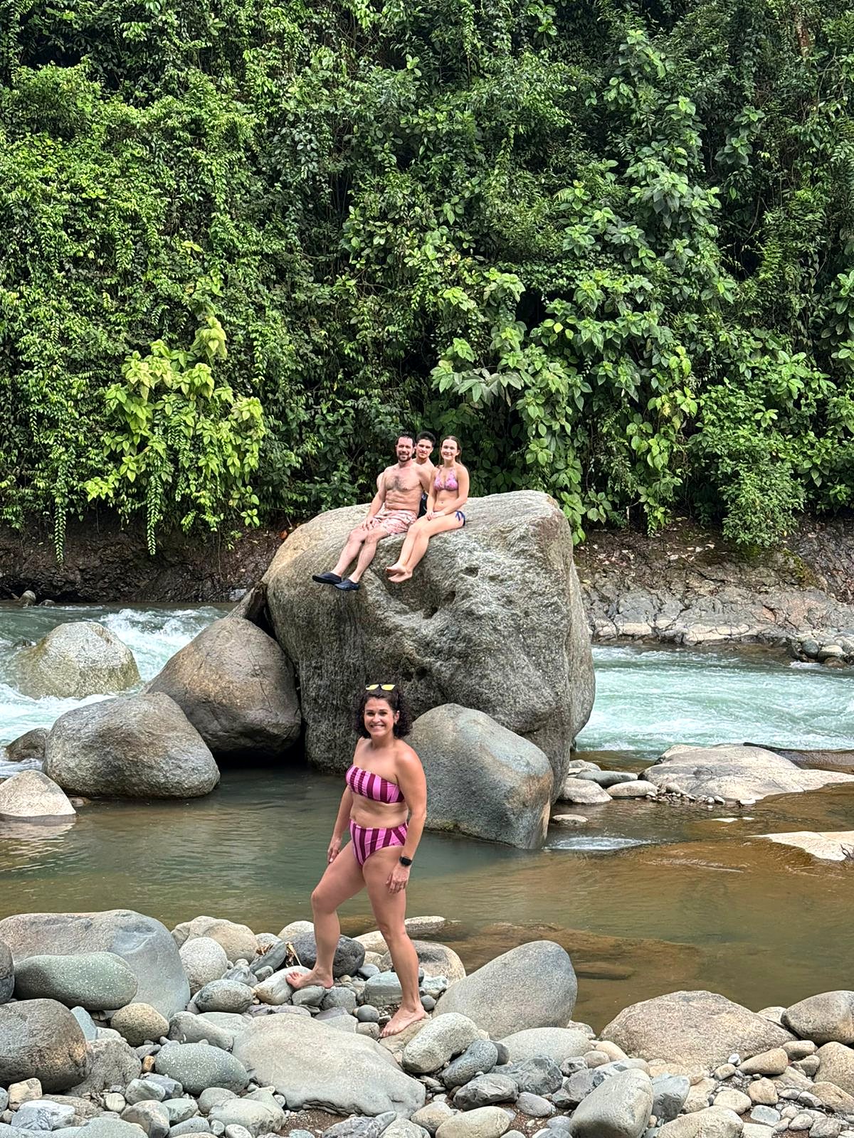 Guests on a big rock in the river