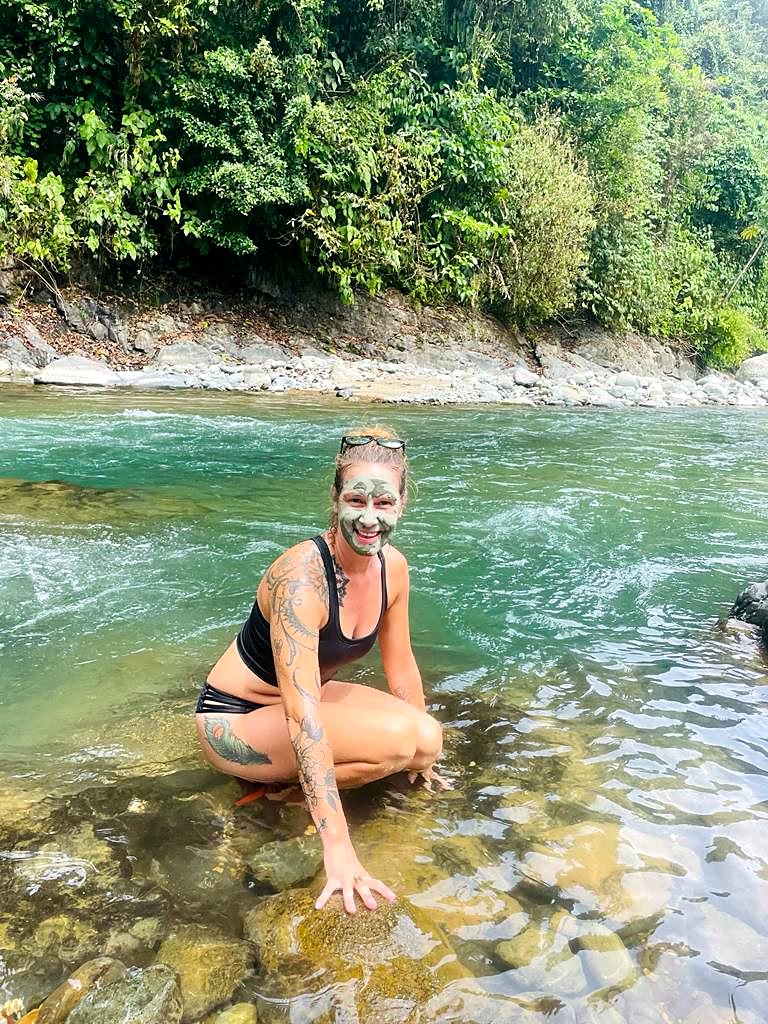 A guest with a clay mask sitting in the river