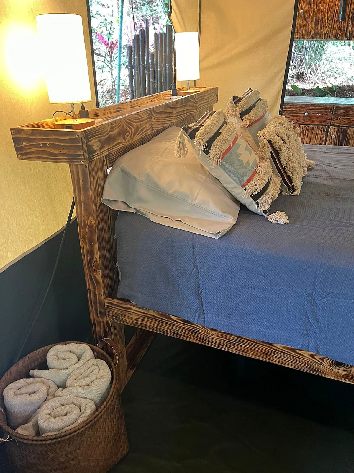 Bedside table with a lamp and folded towels