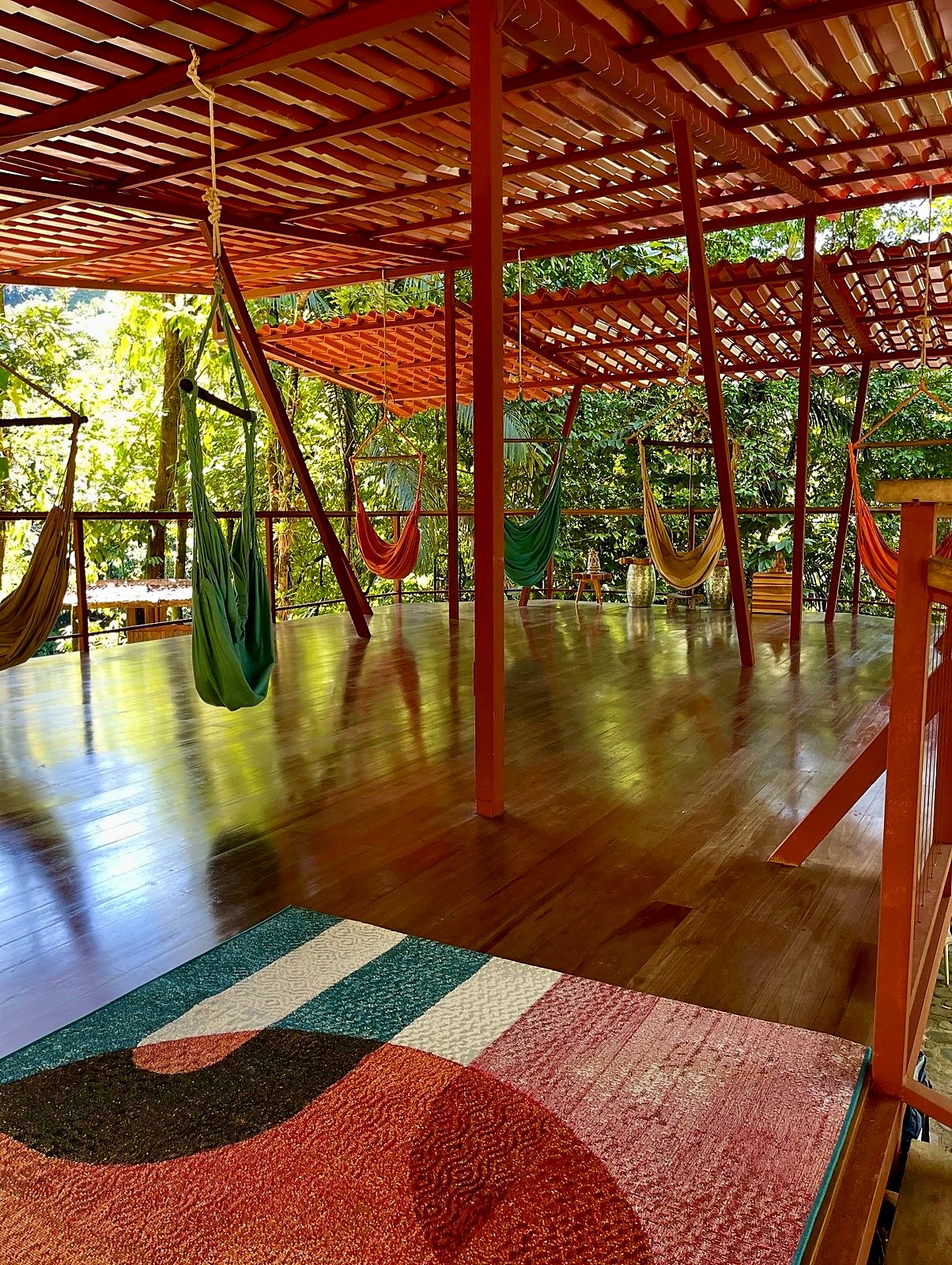 Hammocks and a rug on the upper wooden deck
