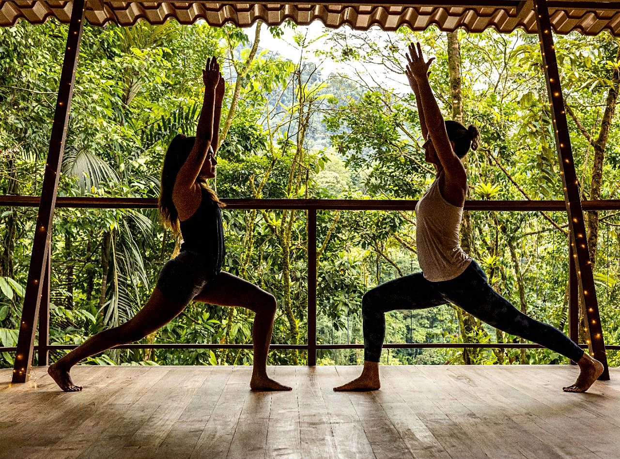 Two guests in a yoga pose on the platform